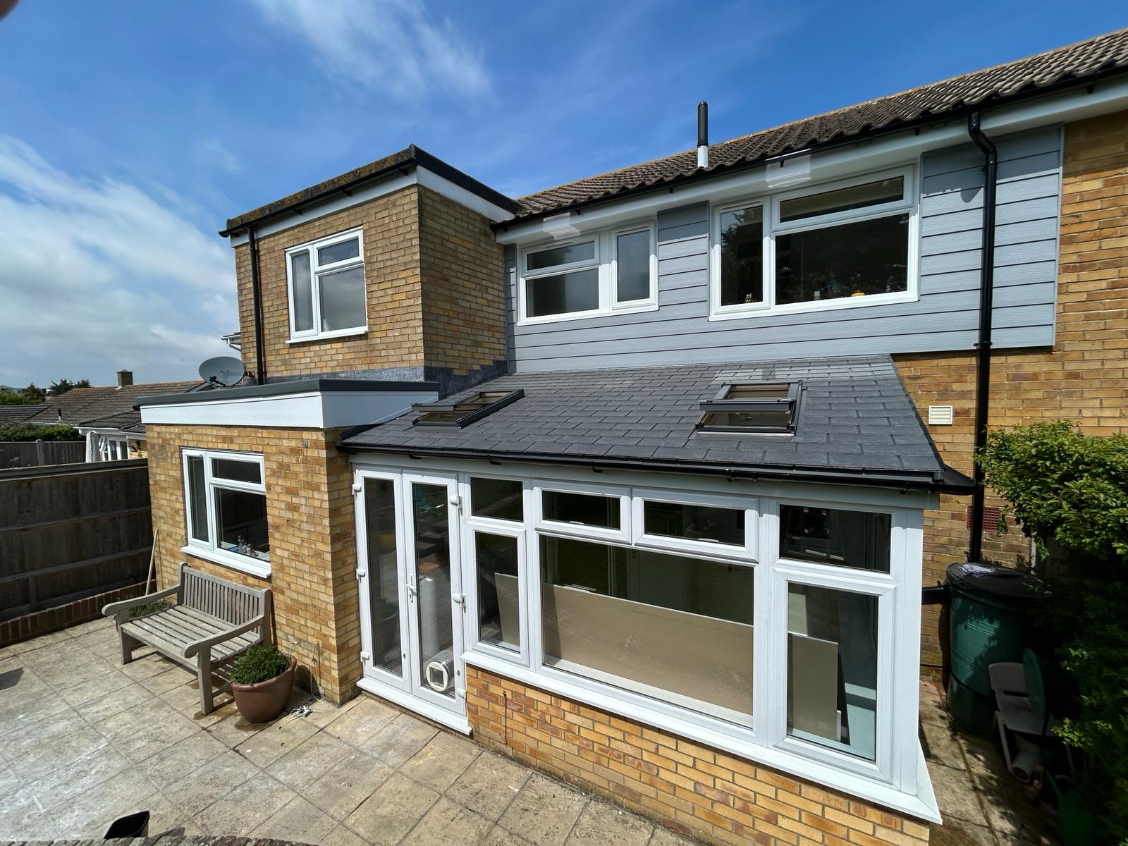Replacement warm roof with cladding and UPVC windows, offering improved insulation and a modern, clean finish.