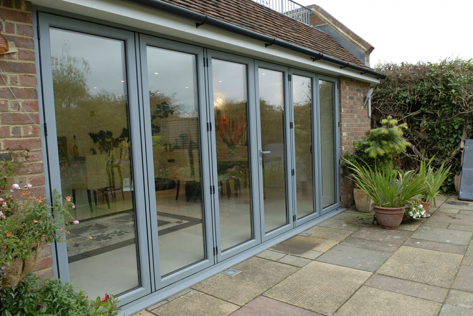 Large glazed aluminium bi-fold door system installed at the rear of a home