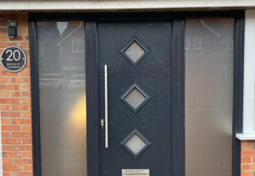 new black composite door with side upvc windows and frosted glass in worthing