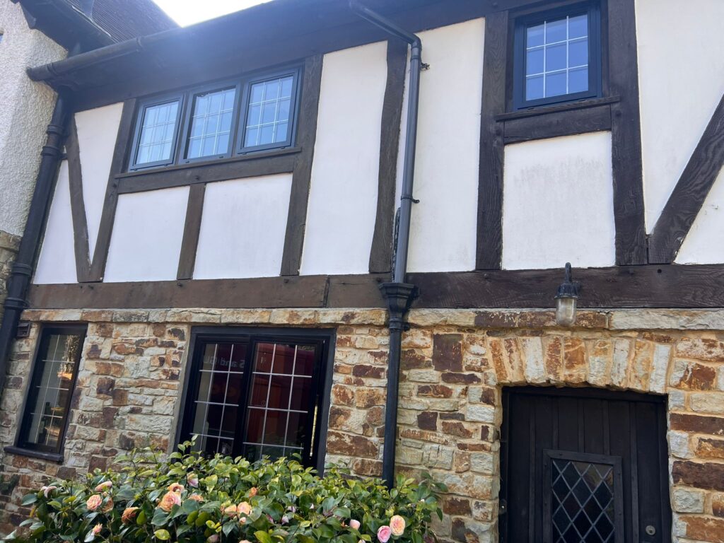 After front of house of new black aluminium windows installed