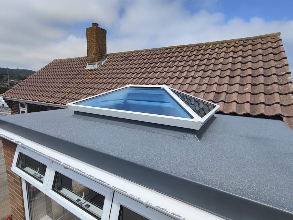 Seamless fibreglass flat roof installation showing weatherproof finish, with a roof glass lantern
