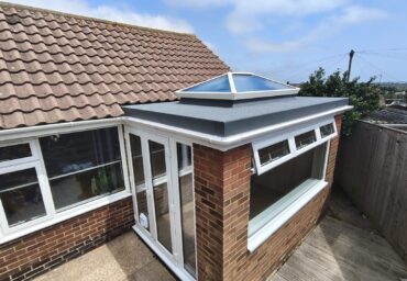 Modern French doors installed in a flat roof bungalow extension with garden access