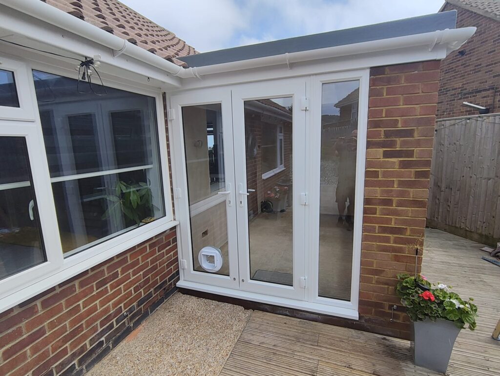 New window and French doors with cat flap in a light-filled roof extension
