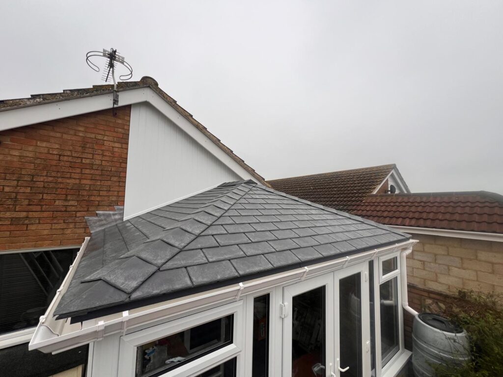Completed flat warm roof conservatory installation with tiled finish using existing base
