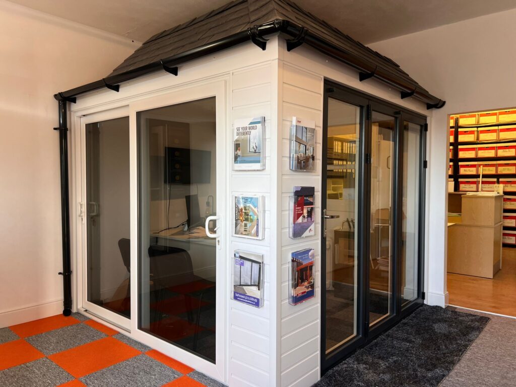 Home extension featuring patio doors and bifold doors with exterior cladding and warm roof tiles in showroom